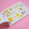 Open book with watercolour-style illustrations on a pink background
