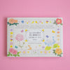 Pack of 100 writing and crafting papers with floral and animal designs on a pink background