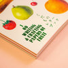 Book titled '100 Writing & Crafting Papers of Fruit' with fruit illustrations on a peach background