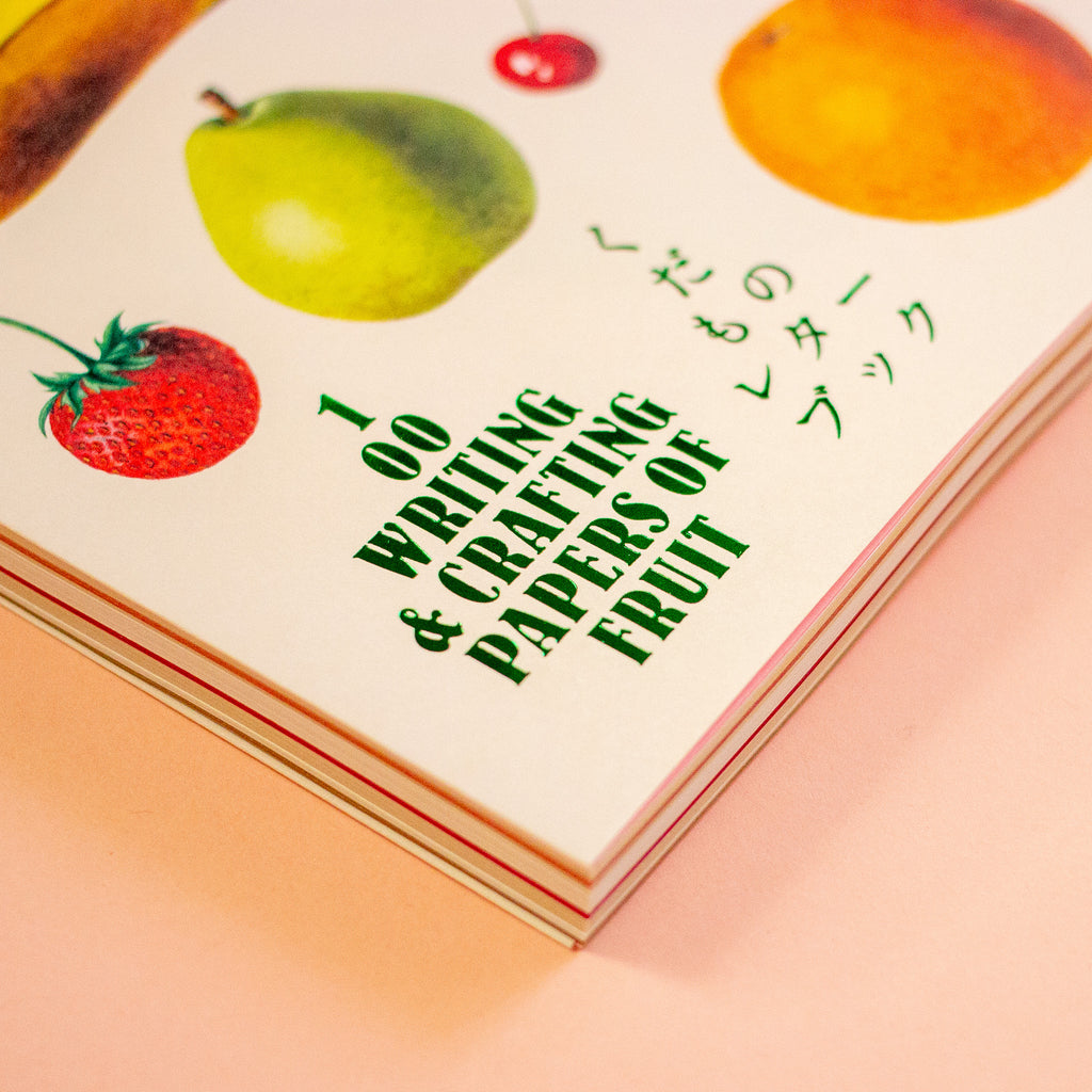 Book titled '100 Writing & Crafting Papers of Fruit' with fruit illustrations on a peach background
