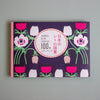 Japanese retro-themed letterbook collection book cover featuring a dark purple background with pink, white, and green floral illustrations, and a central white oval with Japanese and English text.