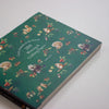 Notebook with forest-themed illustrations on a white background