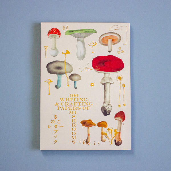 Book cover with illustrations of mushrooms on a blue background