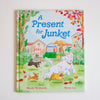 Children's book titled 'A Present for Junket' with illustrations of dogs and a house on the cover.