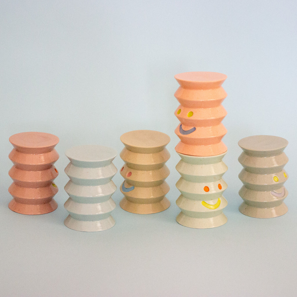 Set of colorful ceramic figurines on a light gray background