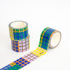 Three rolls of colorful checkered tape on a white background