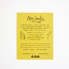 Yellow label with text and branding for Anna Seed on a white background