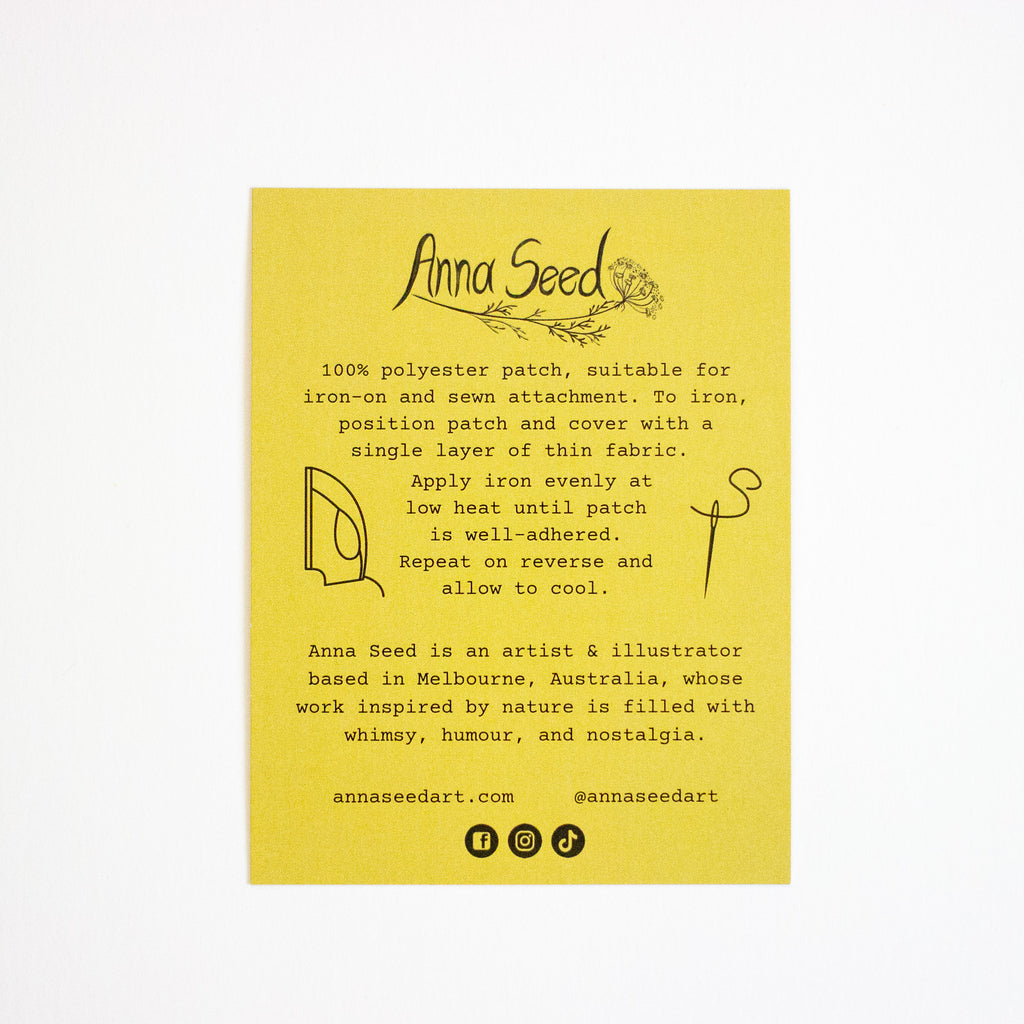 Yellow label with text and branding for Anna Seed on a white background