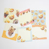 A set of cute bear-themed stationery notepads and memo cards arranged on a plain white background. The designs feature various pastel colors including yellow, pink, blue, and orange, with illustrations of bears, flowers, and food items.