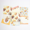 A set of cute, pastel-themed stationery cards featuring cartoon teddy bears, flowers, and food illustrations, arranged on a plain white background.