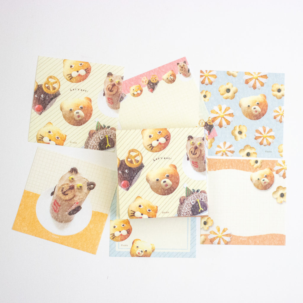 A set of cute, pastel-themed stationery cards featuring cartoon teddy bears, flowers, and food illustrations, arranged on a plain white background.