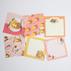 A set of cute breakfast-themed stationery memo sheets with illustrations of pancakes, strawberries, and cat faces on pink, orange, and yellow backgrounds.