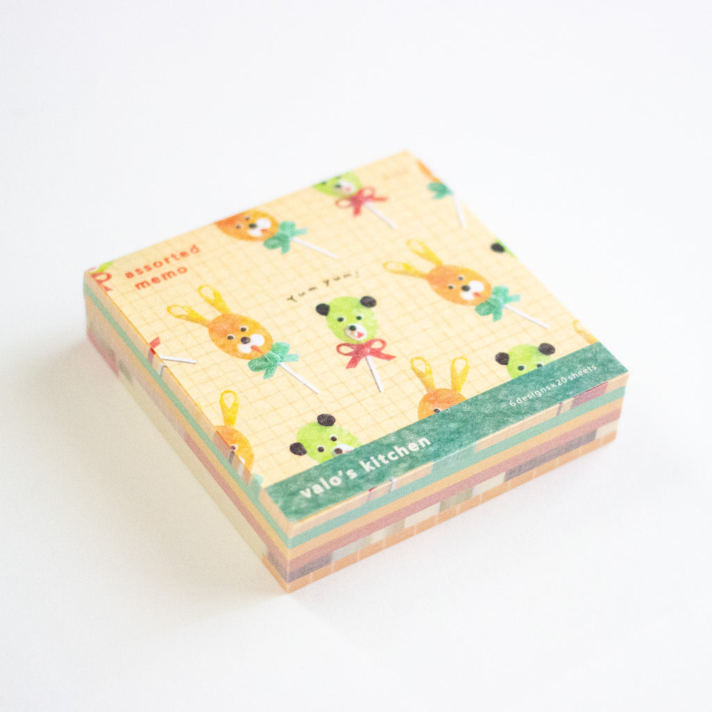 A stack of cute memo sheets with a pastel pattern of cartoon animals on a grid background, featuring a green band that reads 'valo's kitchen' and ' assorted memo'.