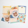 A set of cute bear-themed memo sheets, featuring illustrations of teddy bears, food, and patterned borders in pastel colours.