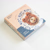 A stack of colourful memo pads, featuring a cute teddy bear face made from a sandwich on a patterned plate. 
