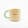 Ceramic mug with a face design on a white background