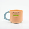 Ceramic mug with a face on a white background