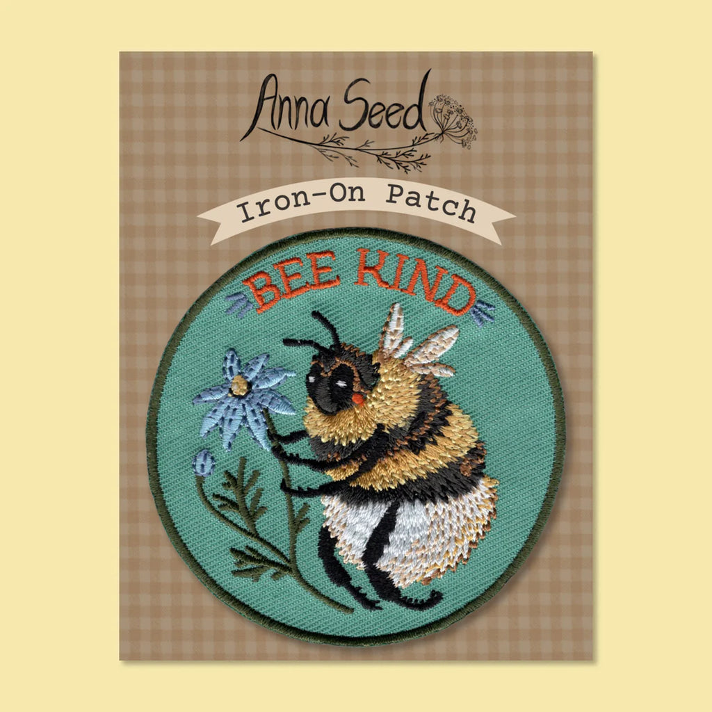 Iron-on patch with bee design and 'Bee Kind' text on a checkered background