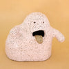 Handbuilt ceramic figurine by shuh. with a speckled pink glaze, open mouth, and protruding tongue. Sculptural artwork made from stoneware clay for the Well Wishes exhibition.