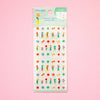 Sticker sheet featuring colourful mini flowers, leaves, and small decorative motifs on a white backing card with a mint green header, set against a solid pink background.