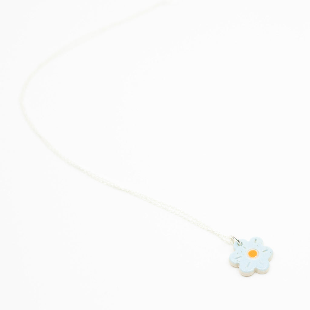 Flower-shaped pendant on a white background
