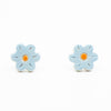 A photo of the bluebell stud earrings. Ceramic earrings with a flower shape and light blue colour leaves with a orange centre.