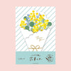 A envelope-style die-cut letter featuring a bouquet of yellow flowers wrapped in a white paper sleeve with gold foil script reading 'For you' and a gold bow. The card has diagonal mint green stripes, a light blue bottom band with Japanese text, and is photographed against a solid pale pink background.