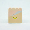 Small rectangular ceramic figure with scallop top and a smiley face design on a light gray background