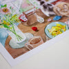 Illustration of a table setting with food, flowers, and a cat.