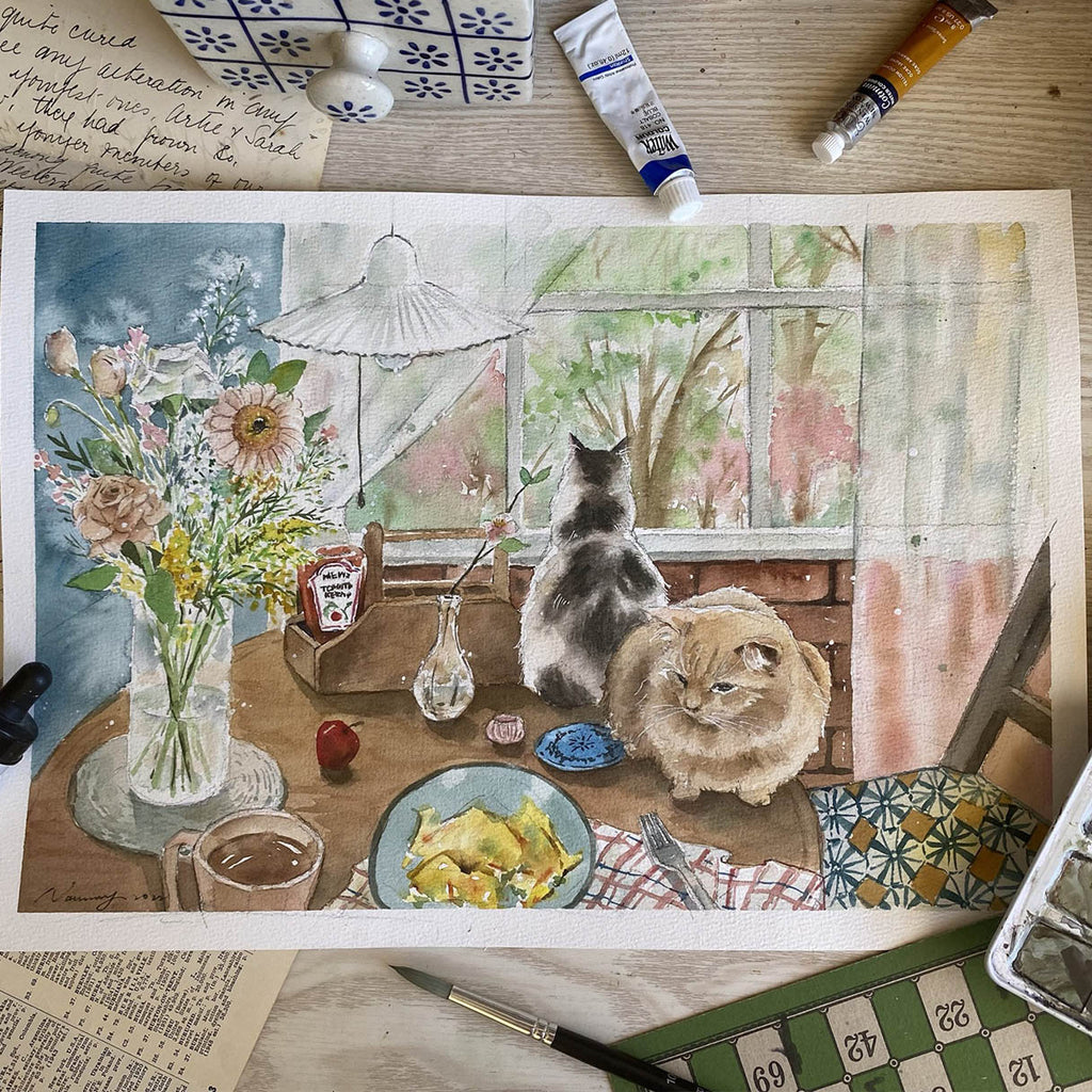 Artistic depiction of two cats at a table with food and flowers, surrounded by art supplies.