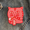 Pink cat patch on a denim background