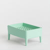 A mint green rectangular plastic tray with legs and a perforated bottom, shown on a clean light grey background.