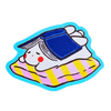 A cute cartoon sticker of a white bunny wearing a blue cap and lying on a pink and yellow striped blanket, outlined in bright blue, shown on a plain white background.