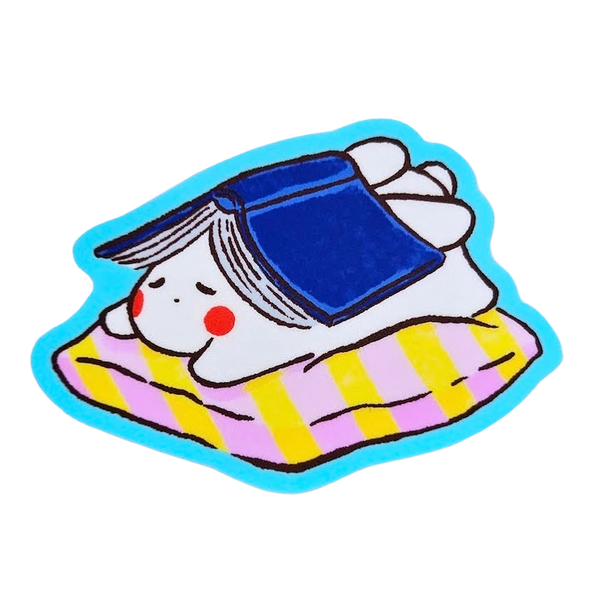 A cute cartoon sticker of a white bunny wearing a blue cap and lying on a pink and yellow striped blanket, outlined in bright blue, shown on a plain white background.