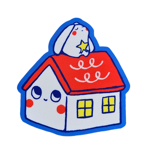 A cute cartoon house sticker or patch featuring a white house with a red roof, blue outline, yellow windows, and a white bunny on top holding a star, shown on a plain white background.