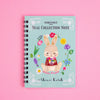 A spiral-bound notebook titled 'Removable Seal Collection Note' by Shinzi Katoh, featuring a cute bunny illustration on a pastel blue striped cover, set against a solid pink background.