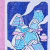 A rectangular art print featuring a stylised illustration of several rabbits wrapped in patterned blankets, with a small teapot, on a white background with a pink textured area at the left edge.