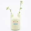 A frontview of the yellow ceramic pottery bunny vase. 