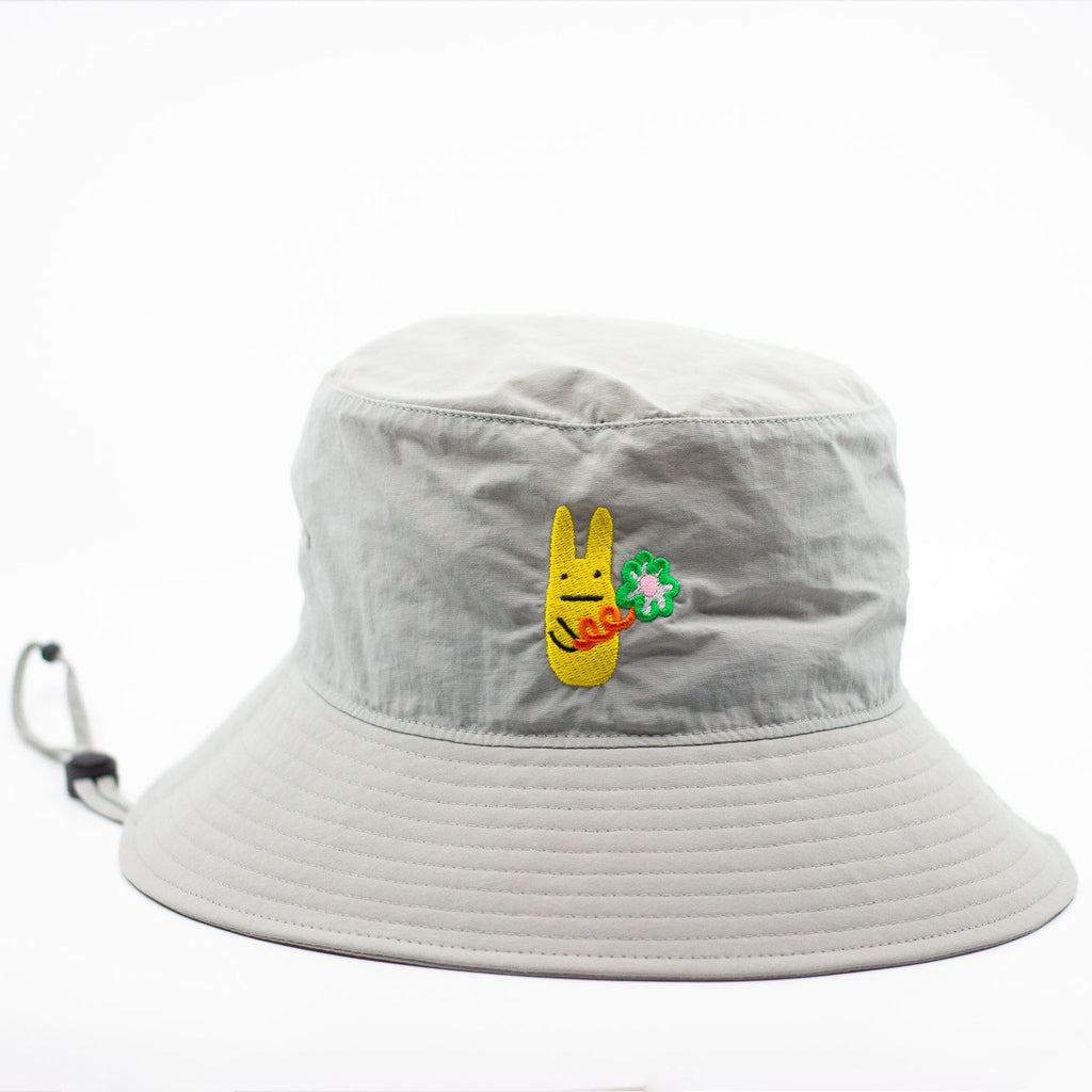 Light grey bucket hat with embroidered design on a white background