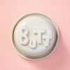 Dish with lid with 'BUTT' text on a peach background