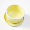 Yellow ceramic bowl and plate set on a white background