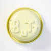 Lid with 'BUTT' embossed on a white background