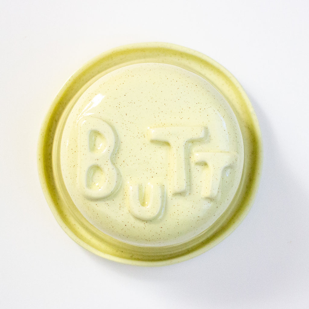 Lid with 'BUTT' embossed on a white background