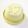 Yellow ceramic butter dish with 'BUTT' letters on a white background