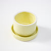 Two light yellow ceramic bowls on a white background