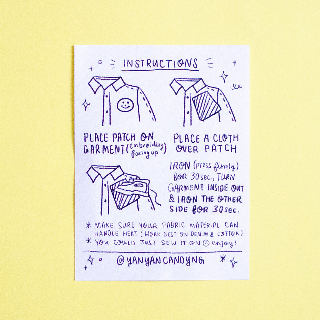 A printed instruction card with hand-drawn illustrations and text showing how to patch and iron fabric, placed on a pale yellow background.