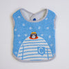 A baby bib made from textured blue and white striped fabric, featuring a cartoon cat peeking out of a striped jumper and a blue pocket-shaped patch with a white letter 'C' in the center. The bib has grey and white striped trim and a blue snap closure at the neckline, shown flat on a white background.