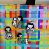 Enamel pin featuring a girl and a dog touching noses, surrounded by a set of enamel pins on a colourful bag. 