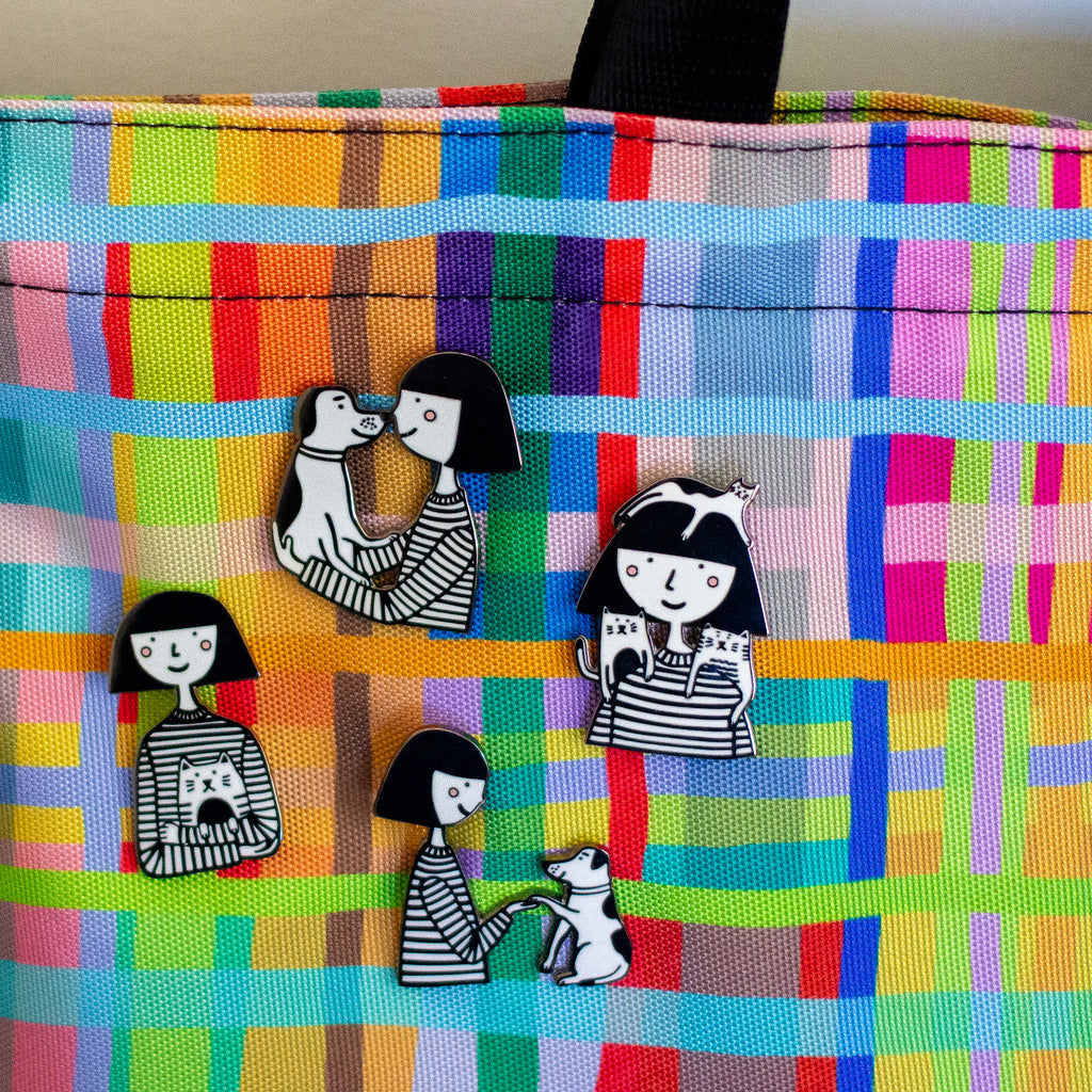 Colorful fabric with cartoon character pins on a checkered pattern