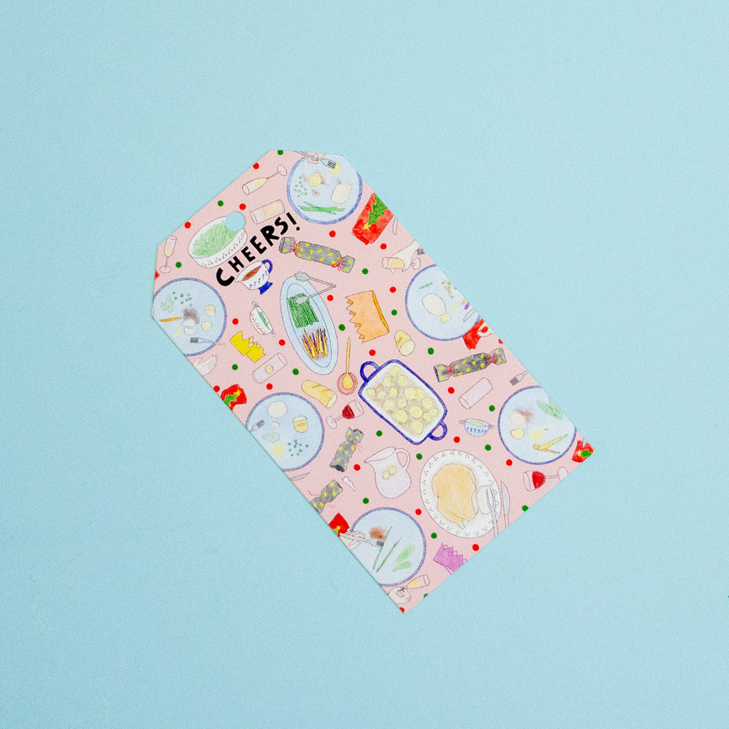 A gift tag with colourful food themed drawings on a blue background.
